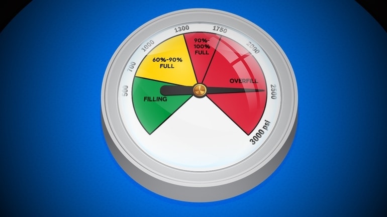 Pressure gauge shaped like a poker chip with the needle in the red